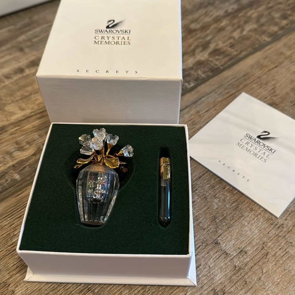 Swarovski crystal flowers in a vase with miniature crystals inside vase.